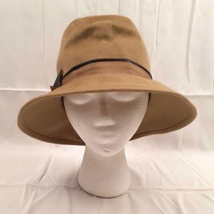 May include: A wide-brimmed brown felt hat with a black leather band.