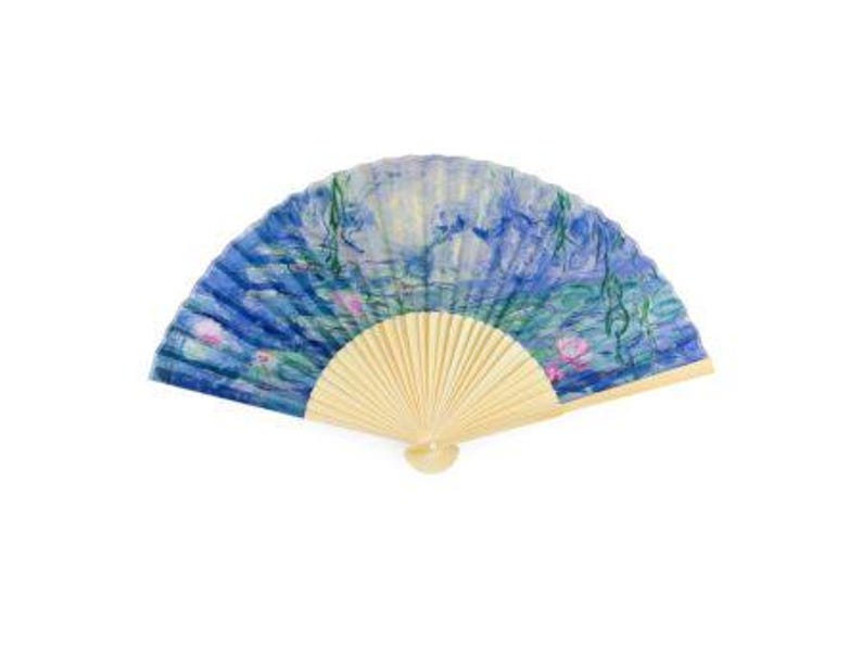 May include: A blue and white hand fan with a painted design of water lilies and a bamboo handle.