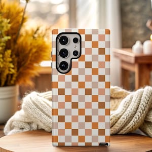 May include: A phone case with a checkered pattern in shades of brown and white.