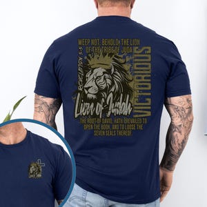 May include: A navy blue t-shirt featuring a graphic of a lion with a crown, the text "Lion of Judah" and the text "Revelation 5:5 Weep not: Behold, the Lion of the Tribe of Judah Victorious The root of David, hath prevailed to open the book, and to loose the seven seals thereof."