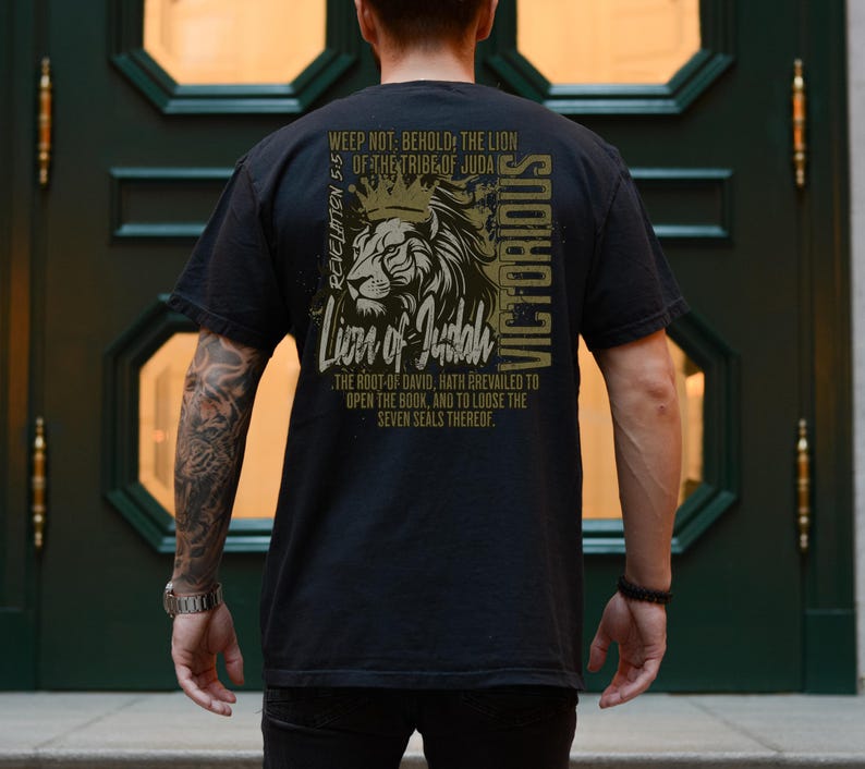 May include: Black t-shirt featuring a lion graphic and the text "Weep not: Behold, the Lion of the Tribe of Juda Revelation 5:5 Lion of Judah The root-of David, hath prevailed to open the book, and to loose the seven seals thereof. Victorious"