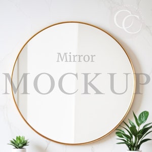 May include: A gold round mirror with a white background. The mirror is hanging on a white wall with a marble pattern. The text "Mirror Mockup" is written in gray on the mirror.