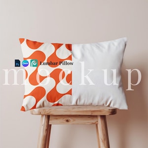 May include: Orange and white lumbar pillow with a geometric pattern on a wooden stool. The pillow is labeled "Lumbar Pillow".