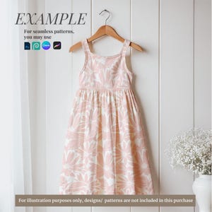 May include: A pink sleeveless dress with a floral pattern. The dress has a gathered skirt and a simple bodice. The dress is hanging on a wooden hanger against a white background.