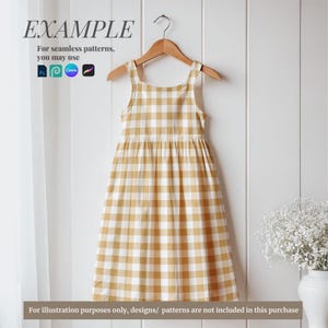 May include: A yellow and white gingham sleeveless dress hanging on a wooden hanger against a white wood panel background. The dress has a square neckline and a gathered skirt.