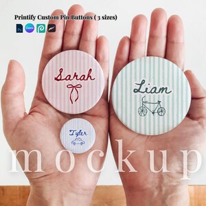 May include: Three round pin buttons in different sizes featuring striped patterns. One pink button displays the name Sarah with a bow, one blue button shows the name Tyler with a car, and one teal button features the name Liam with a bicycle graphic.