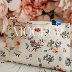 May include: A white canvas pouch with a floral print featuring red berries, green leaves, and pink flowers. The pouch has a zipper closure and the text "Pouch MOCKUP" is printed on the front.