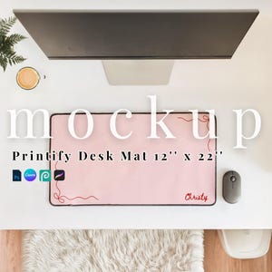 May include: A light pink Printify desk mat, measuring 12" x 22", with a red decorative design and the name "Christy" in red. A computer mouse is to the right of the mat. The word "mockup" is in large white letters.