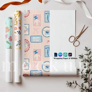 May include: A flat lay featuring rolls of patterned wrapping paper, a partially unrolled sheet with a postal-themed design, scissors, and ribbons. The wrapping paper has floral and postal designs. The text "Wrapping Paper & Ribbon" is visible.