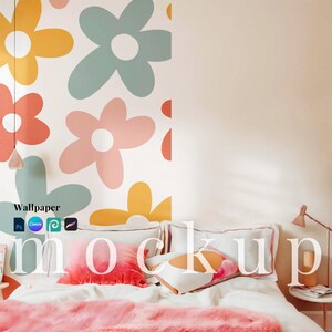 May include: A bedroom mockup featuring a bed with white linens, decorative pillows, and a pink faux fur throw. The wall is adorned with a floral wallpaper design in pastel colors. The word "mockup" is displayed on the pillows.