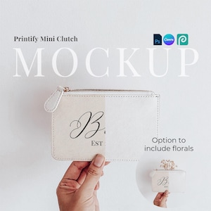 May include: White leather mini clutch with a zipper closure. The clutch has a gold zipper and a black script letter "B" with "EST" underneath. The clutch is being held by a hand. There is an option to include florals.