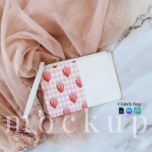 May include: White clutch bag with a pink and white gingham pattern featuring strawberries on one side. The other side is solid white. The bag has a white zipper and a white strap.