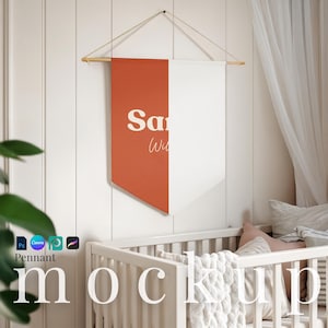May include: A two-toned pennant banner with a burnt orange and white design. The banner is hanging from a wooden dowel and string. The text "Sa Wil" is printed on the orange side. The banner is displayed above a white crib.