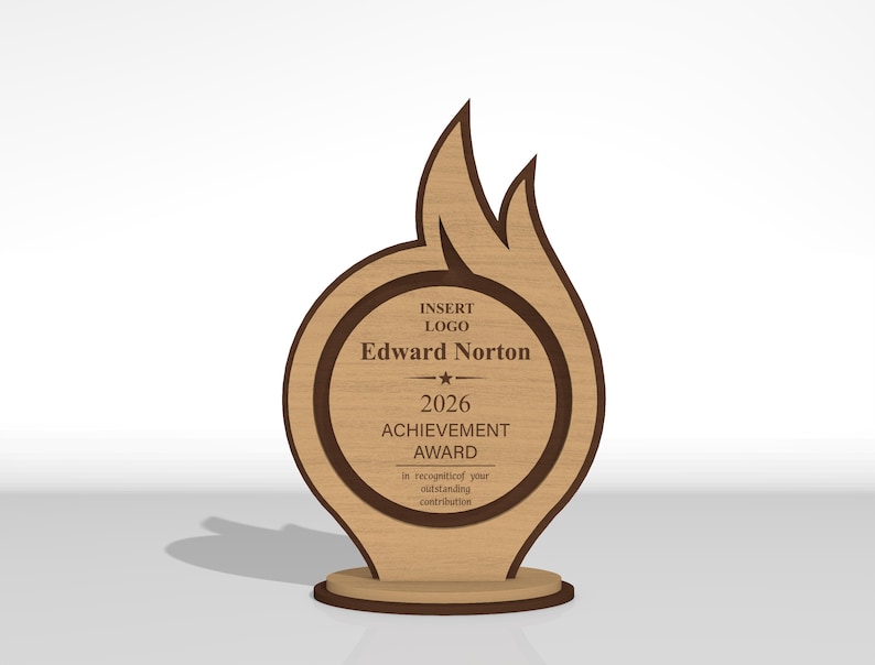 May include: A light brown wooden award plaque shaped like a flame with a circular center. The text reads: INSERT LOGO, Edward Norton, 2026 ACHIEVEMENT AWARD, in recognition of your outstanding contribution. It features a dark brown border and base.