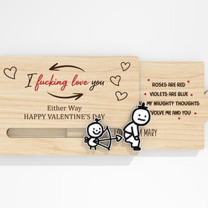 May include: A wooden Valentine's Day card with a sliding mechanism. The card features the text "I fucking love you" and "Either Way HAPPY VALENTINE'S DAY". The card also has a poem and cartoon illustrations.