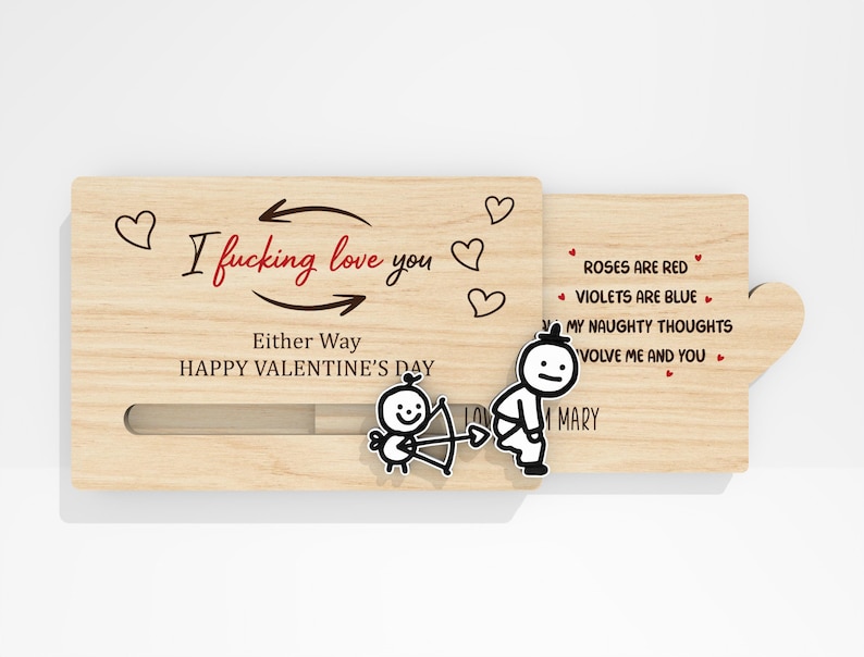 May include: A wooden Valentine's Day card with a sliding mechanism. The card features the text "I fucking love you" and "Either Way HAPPY VALENTINE'S DAY". The card also has a poem and cartoon illustrations.