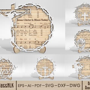 Puede incluir: Piezas de arte religioso de madera cortadas con láser. Una presenta una cruz y el texto "Jesus Christ Is Risen Today" sobre partituras. Otros diseños incluyen una corona de espinas y cruces. Las piezas están montadas sobre pequeños soportes de madera.