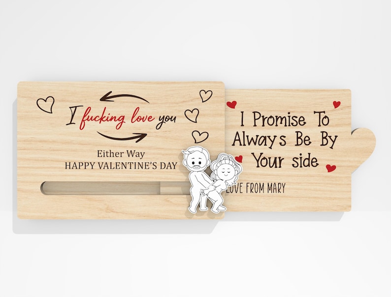 May include: A wooden Valentine's Day card with the text "I fucking love you" and "I promise to always be by your side." The card features a sliding mechanism and a cartoon couple illustration. Red hearts and the words "Happy Valentine's Day" are also present.