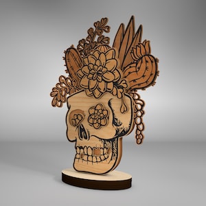 May include: A wooden skull sculpture with a floral design. The skull is brown and the flowers are white and green. The sculpture is on a wooden base.