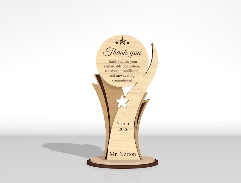 May include: A light-colored wooden trophy with a circular top featuring a star and the text Thank you for your remarkable dedication, consistent excellence, and unwavering commitment. Below is a star cutout, Year of 2026, and Mr. Norton.