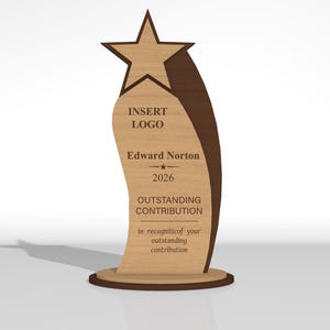 May include: A wooden award plaque featuring a star at the top and a curved design. The text reads: INSERT LOGO, Edward Norton, 2026, OUTSTANDING CONTRIBUTION, and in recogniticof your outstanding contribution. The plaque has a light and dark wood finish.