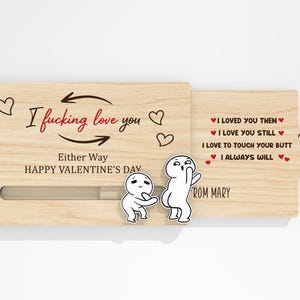 May include: A wooden Valentine's Day card with the text "I fucking love you" and "Either Way HAPPY VALENTINE'S DAY". The card features cartoon figures and the message "I loved you then, I love you still, I love to touch your butt, I always will".