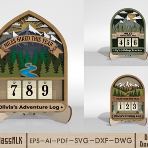 May include: Wooden hiking tracker with a mountain and forest design. The tracker displays "Miles Hiked This Year" and has a counter with the numbers 789. The base reads "Olivia's Adventure Log."