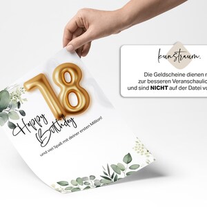 May include: A white card with a gold foil 18 on it. The card has a green leafy design and the text "Happy Birthday" and "und viel Spa&szlig; mit deiner ersten Million!"  The card is being held by a hand. The text "kunstraum. Die Geldscheine dienen nur zur besseren Veranschaulichung und sind NICHT auf der Datei vorhanden!" is on a separate white card.