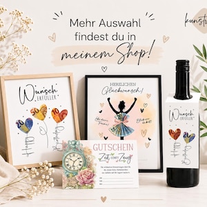 May include: A display of framed art prints, a wine bottle with a gift tag, and a gift certificate. The art features heart-shaped balloons with currency values and the words "Happy Birthday." The wine tag and art say "Wunsch Erf&uuml;ller." The text "Mehr Auswahl findest du in meinem Shop!" is also visible.