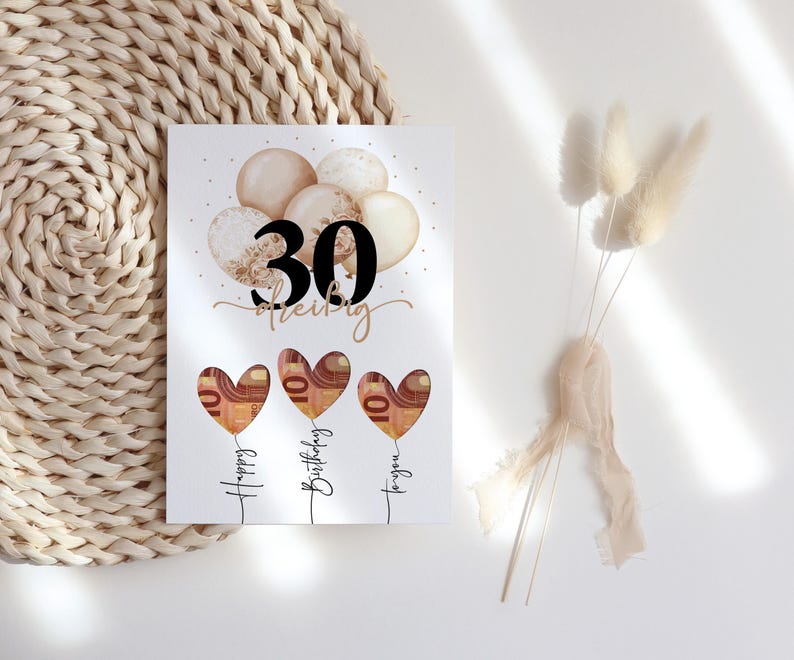 May include: A birthday card with the number 30 in black, the name "Shelby" in cursive, and three heart-shaped balloons with money inside. The balloons are labeled "Happy Birthday to you."