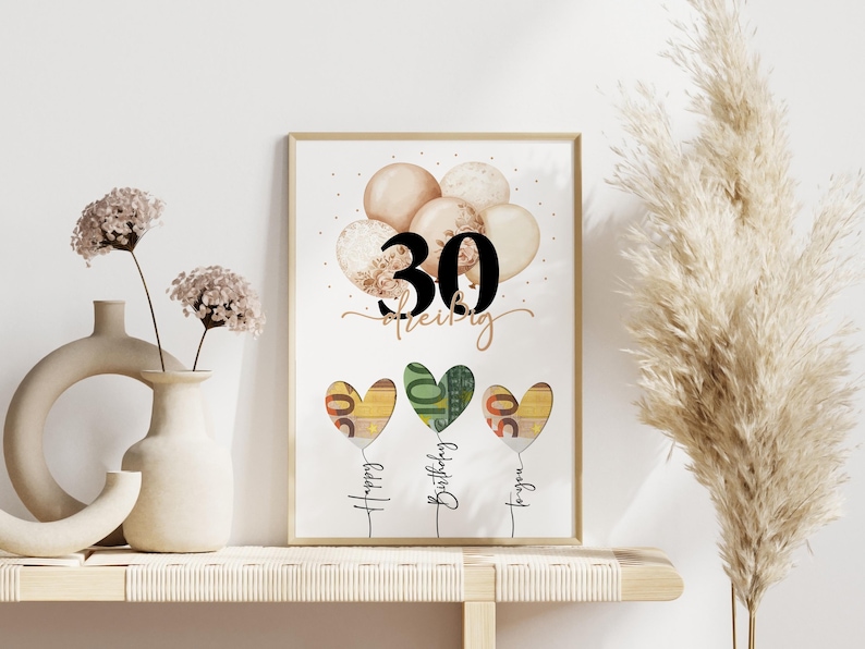 May include: A framed print with a birthday theme. The print features the number "30" above a series of heart-shaped balloons. The balloons are in shades of beige and gold. Below the balloons are three heart-shaped balloons made of currency, with the words "Happy Birthday to you".
