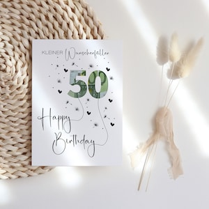 May include: A white card with black text that reads "KLEINER Wunscherfallen" and "Happy Birthday". The number 50 is made of a euro bill and surrounded by black hearts and dandelion seeds.