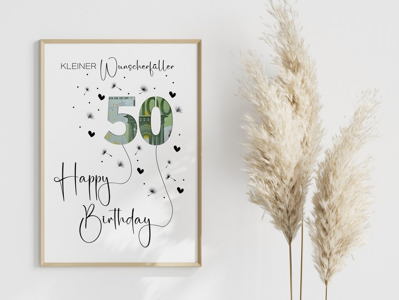 May include: A white framed print with the text "KLEINER Wunscherraller" and "Happy Birthday" with a 50 euro bill shaped like a balloon with dandelion seeds and hearts around it.
