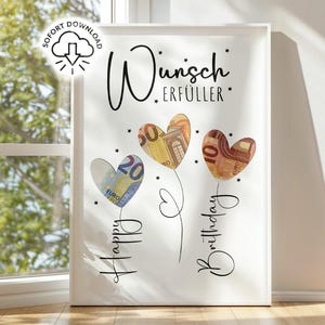 May include: White framed art print featuring three heart-shaped flowers made of Euro banknotes. The words "Happy Birthday" and "Wunsch Erf&uuml;ller" are written in cursive. A download icon is in the upper left corner.