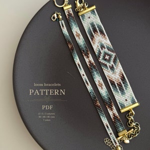May include: Three loom bracelets with a geometric pattern in shades of white, brown, and blue. The bracelets are made with beads and have gold clasps. The image includes the text "loom bracelets PATTERN PDF 13/5/3 columns 95| 85 | 85 rows 7 colors".