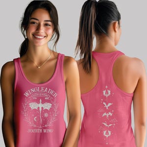 A woman wearing a pink tank top with a dragon design and text on it.
