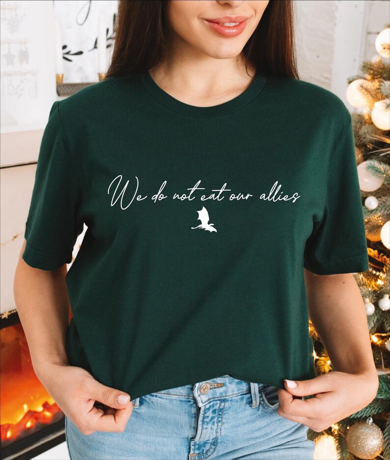 a woman standing next to a christmas tree