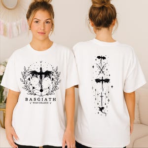 A woman wearing a white t-shirt with a graphic design featuring a dragon and stars on the front and back.