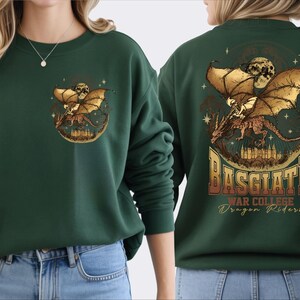 a woman wearing a green sweater with a dragon design and text on the back.