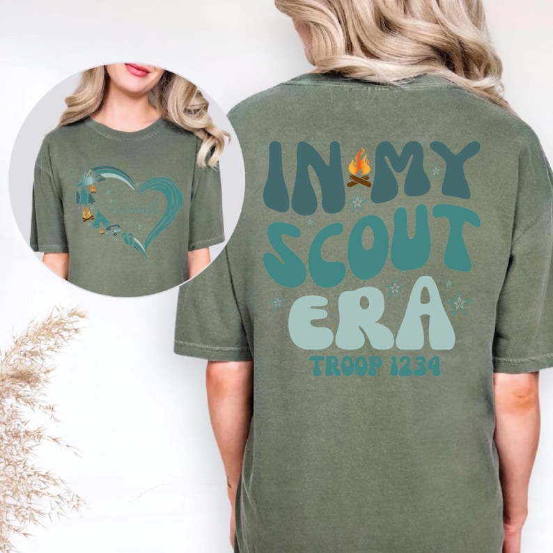 A woman wearing a green t-shirt with text and graphics printed on the back.
