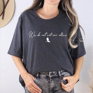 a woman wearing a t - shirt that says we're not too old