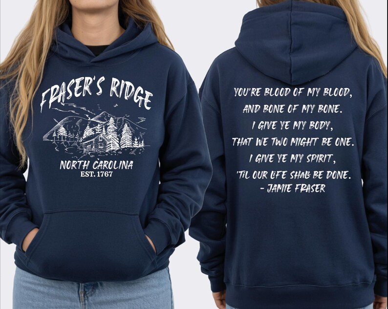 A navy blue hoodie with white text and graphics, including a mountain landscape and a quote.
