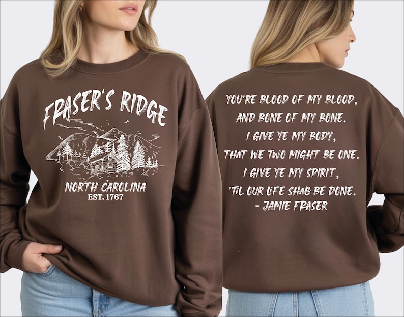 a woman wearing a brown sweatshirt with text and graphics printed on it.