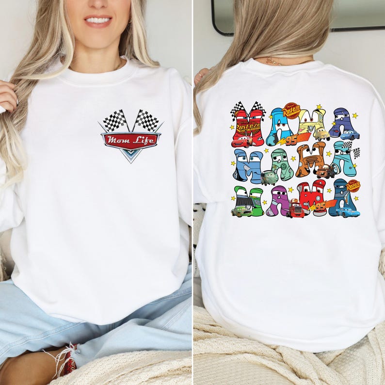 May include: White sweatshirt with a graphic on the front that says "Mom Life" with checkered flags. The back of the sweatshirt features a colorful design of car-shaped letters spelling out "Mom Life".
