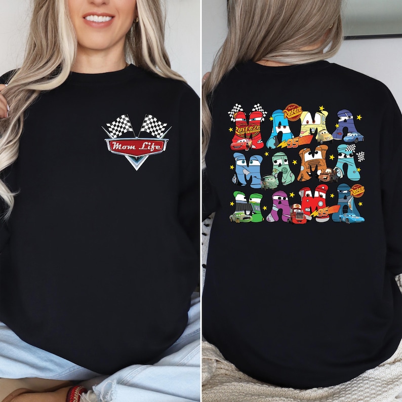 May include: Black sweatshirt with a graphic design featuring the text "Mom Life" and two checkered flags. The back of the sweatshirt has a colorful design of the word "MAMA" with car-themed letters and the number "95".