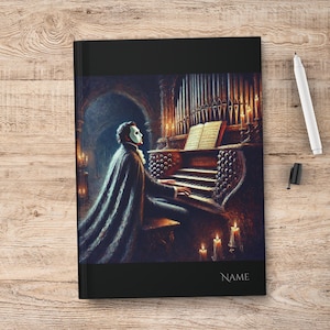 May include: A black and white illustration of a masked figure playing a pipe organ in a dimly lit room. The figure is wearing a long black cape and a white mask. The organ is ornate and has many pipes. There are candles on the organ and in the background.