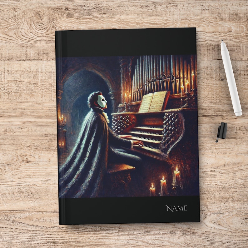 May include: A black and white illustration of a masked figure playing a pipe organ in a dimly lit room. The figure is wearing a long black cape and a white mask. The organ is ornate and has many pipes. There are candles on the organ and in the background.