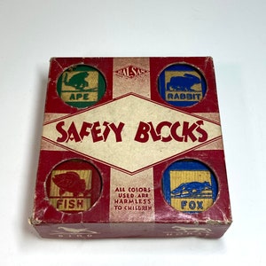 May include: Vintage wooden toy blocks with colorful illustrations of animals, including an ape, rabbit, fish, fox, bird, and horse. The blocks are labeled with the animal names and the box reads "Safety Blocks".