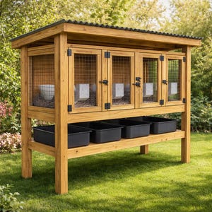 May include: A wooden rabbit hutch with a corrugated metal roof. The hutch has four wire-mesh doors and four black plastic trays. The structure is made of light-colored wood and sits on a grassy lawn.