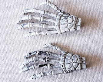 Bony skeleton hand brooch